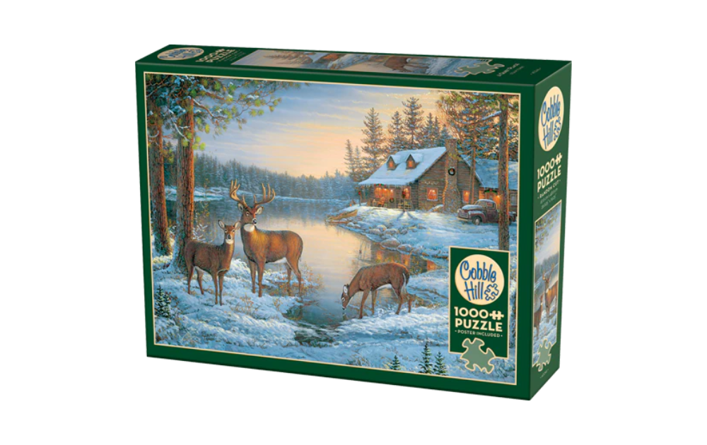 A Quiet Place 1000 Piece Jigsaw Puzzle by Cobble Hill featuring deer by a snowy lakeside cabin
