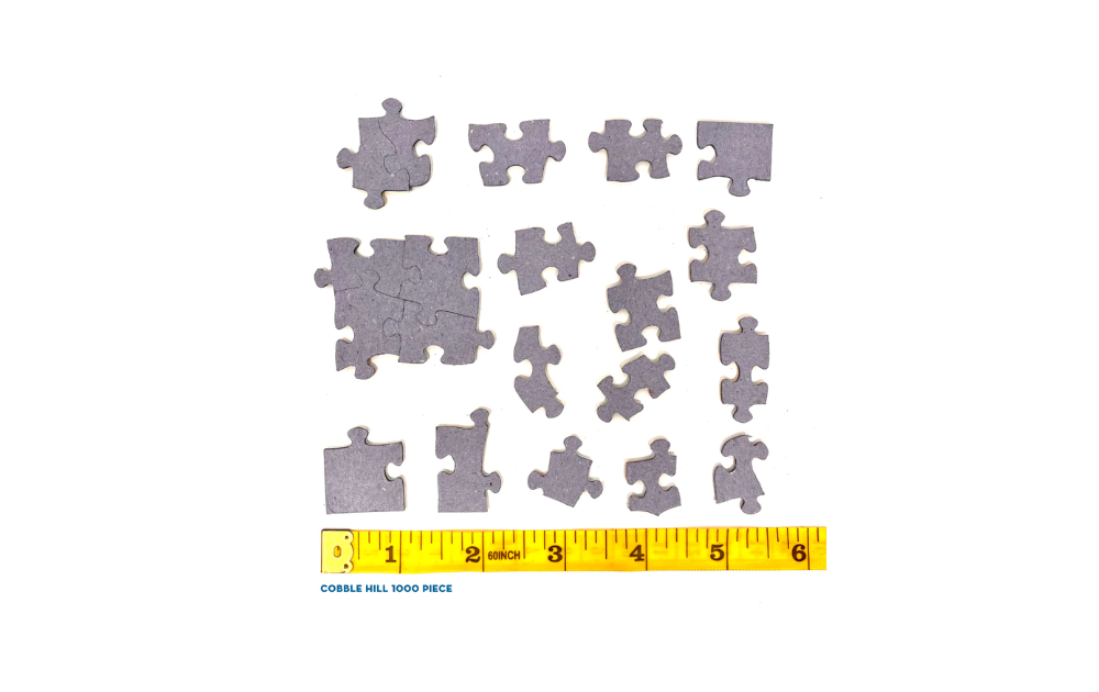 Cobble Hill Brambly Hedge Winter Story jigsaw puzzle loose pieces laid out above a yellow inch ruler showing scale