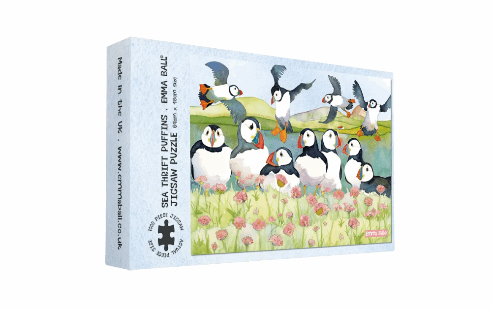 Emma Ball Sea Thrift Puffins puzzle featuring colorful puffins amidst vibrant flowers and scenic landscape
