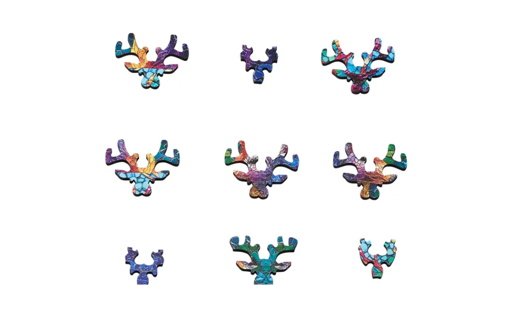 Colourful pieces of the Wentworth extra difficult stag jigsaw puzzle arranged in a creative layout