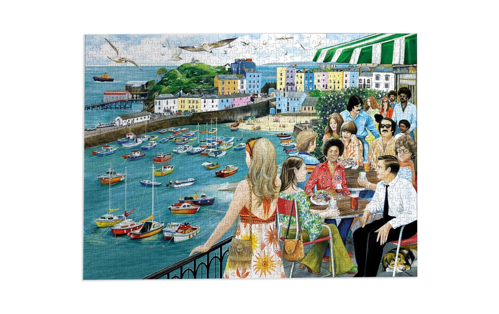 Dining in Tenby jigsaw puzzle by Gibsons showing colourful Tenby harbour with boats and people dining on a seaside terrace