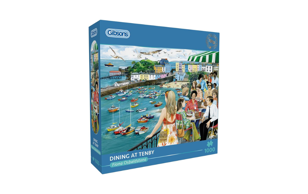 Gibsons Dining in Tenby jigsaw puzzle box showing Tenby harbour with colourful boats and people dining on terrace