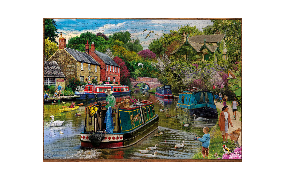 Gibsons River Retreat 1000 piece jigsaw showing completed colourful canal scene with narrowboats cottages swans and people
