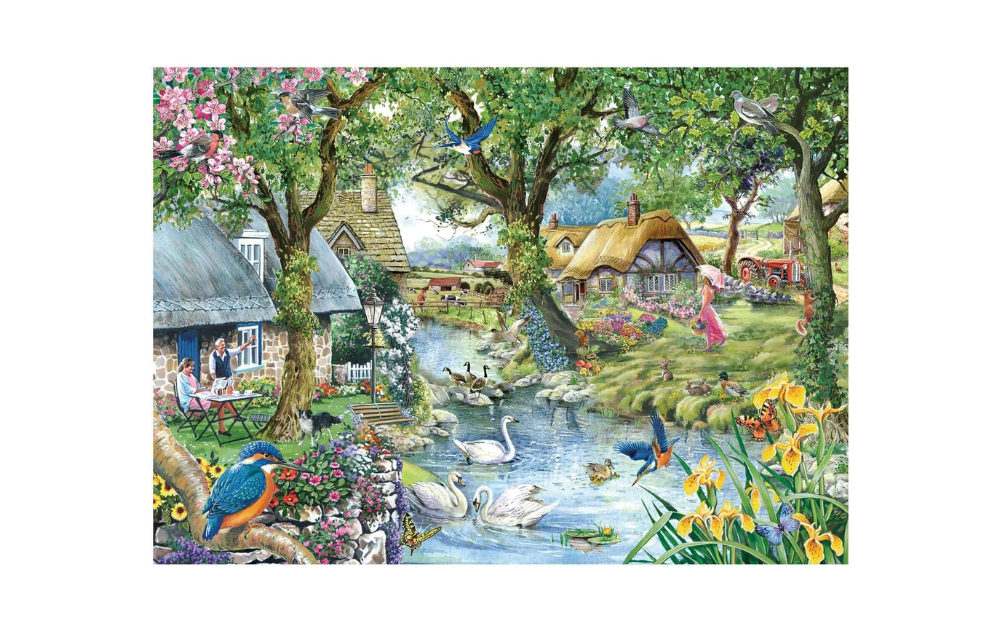 House of Puzzles 1000 Piece Kingfisher Cottage Jigsaw Puzzle featuring a scenic riverside cottage and wildlife