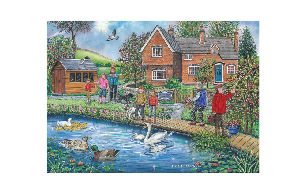 House of Puzzles 250 Piece Plum Cottage Jigsaw Puzzle depicting a tranquil cottage scene with a pond and children.