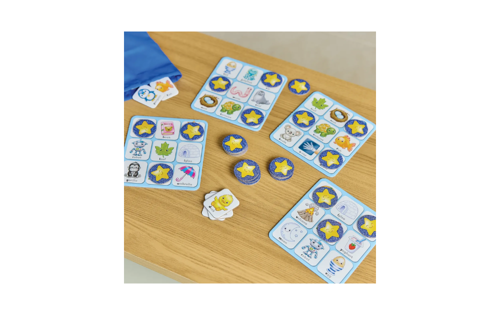 Alphabet Bingo by Orchard Toys featuring colourful cards and game pieces on a wooden table