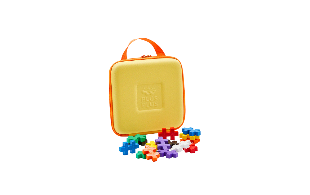 Plus Plus BIG travel case in yellow with colourful building pieces for creative play on the go