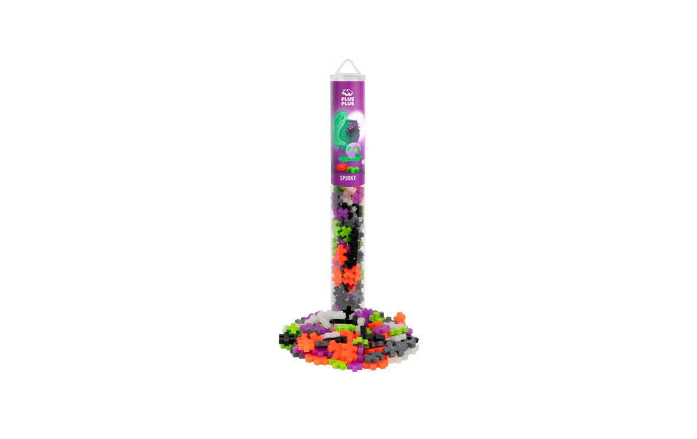 Plus Plus spooky puzzle tube with Halloween colours and neon interlocking pieces scattered around clear display tube