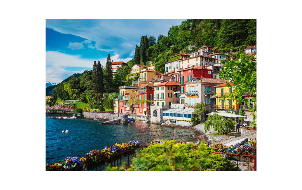 Ravensburger Lake Como puzzle featuring a vibrant lakeside village with colorful buildings and lush greenery