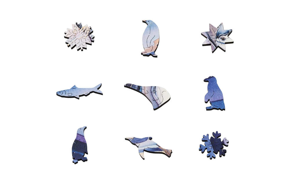 Unique snow themed wooden jigsaw puzzle pieces featuring animals and snowflakes