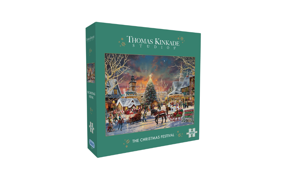 Gibsons Thomas Kinkade Christmas puzzle box showing snowy village Christmas festival scene with lit tree and horse drawn sleigh