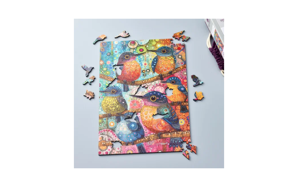 Colourful Wentworth bird jigsaw puzzle partially completed with detailed bird pieces on a light surface