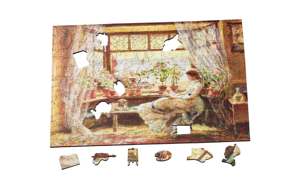 Wentworth Reading by the Window puzzle partially completed with unique shaped pieces and vintage illustration