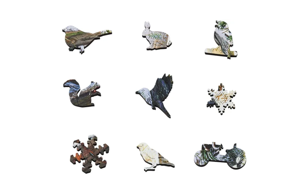 Various intricately shaped pieces of the Safe Haven winter puzzle Wentworth featuring animals and winter motifs