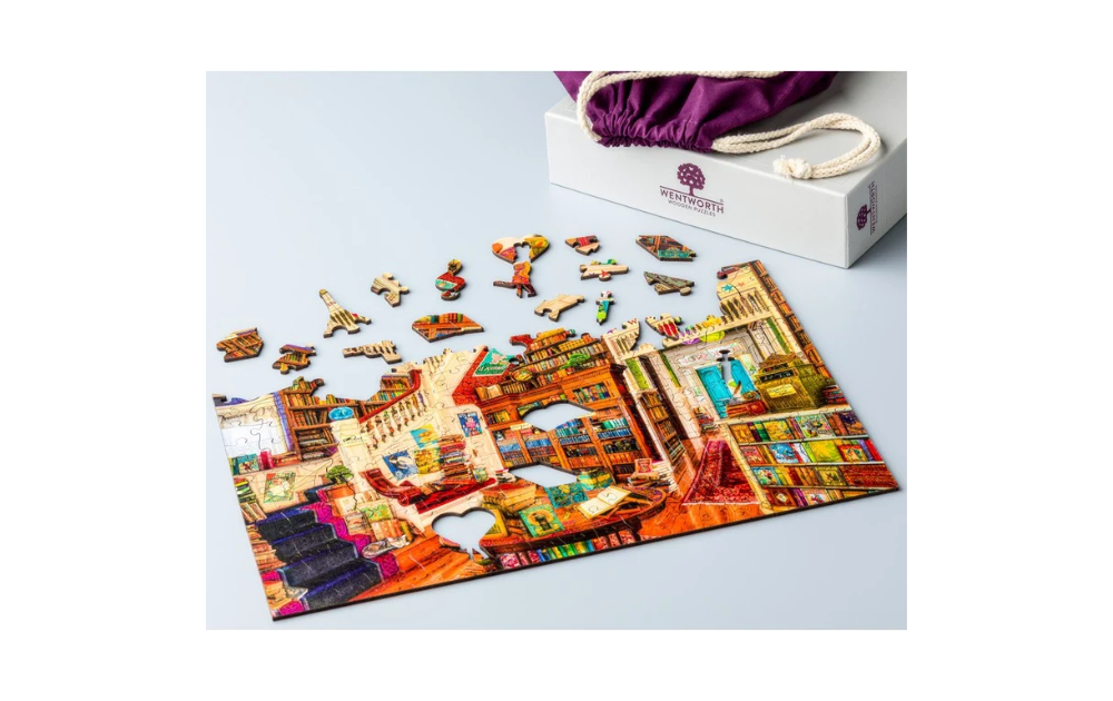 Wish Upon a Bookshop 40 piece puzzle by Wentworth featuring colorful bookshop scene with puzzle pieces.